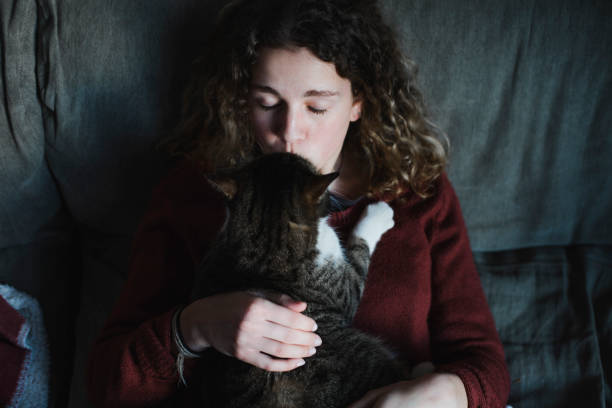 istock Young woman with her tabby cat 918656136