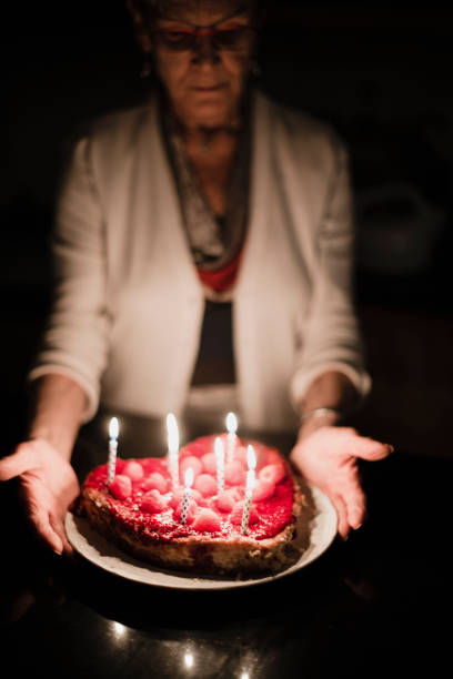 istock Grandmother holding birthday cake 918656210