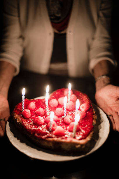 istock Grandmother holding birthday cake 918656218