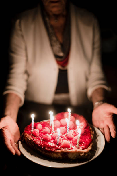 istock Grandmother holding birthday cake 918656234