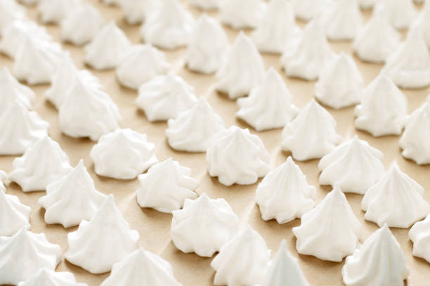 istock Meringue cookies on baking paper ready to bake on the table. 918663648