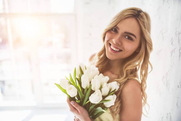 istock Young woman with tulips 918664530