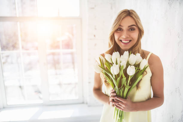 istock Young woman with tulips 918664596