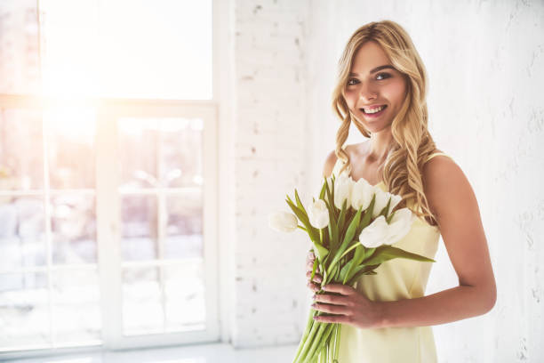 istock Young woman with tulips 918664618