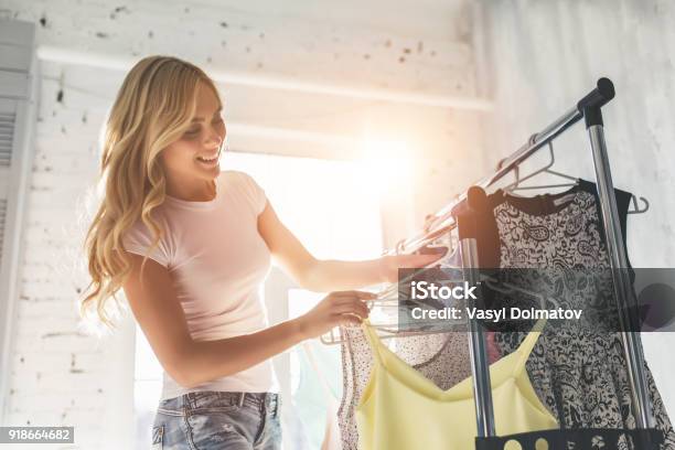 Young Woman Choosing Clothes Stock Photo - Download Image Now - Clothing, Women, Closet