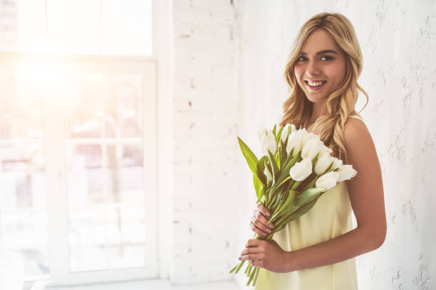 istock Young woman with tulips 918664686