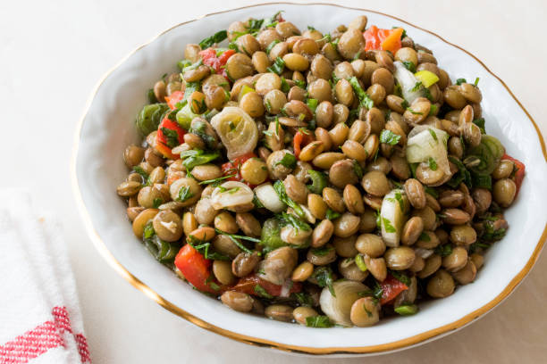 istock Lentil Salad with Onions, Parsley and Tomatoes in Ceramic Bowl. 918666992