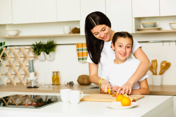 istock Mother teaches her daughter cooking 918673924
