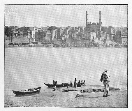 People along the Ganges River with the skyline of Benares, India during the british era. Vintage halftone circa late 19th century. Benares is now modern day Varanasi.