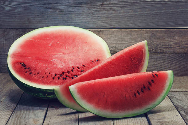 istock Sliced or half of watermelon in wooden  background. Rustick style 918679046