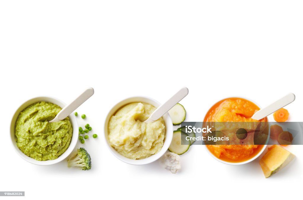 Three bowls of baby puree isolated on white from above Green, yellow and orange baby puree in bowl isolated on white background, top view Pureed Stock Photo