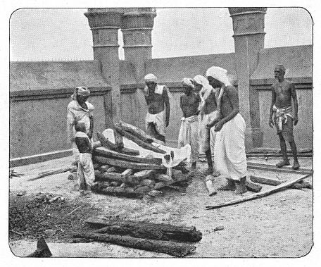 Group of people attending a funeral pyre in Calcutta, India during the british era. Vintage halftone circa late 19th century. Calcutta is now modern day Kolkata.