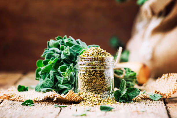 Dried and fresh oregano, vintage wood background, rustic style, selective focus