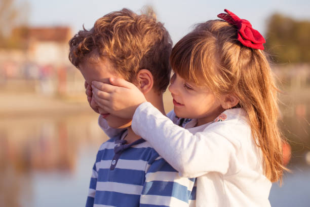 istock Girl puts hands on boys eyes 918695006