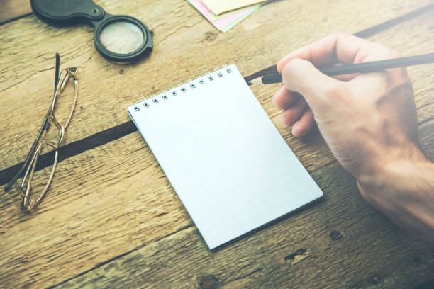 istock businessman writing with notepad on the desk 918695192