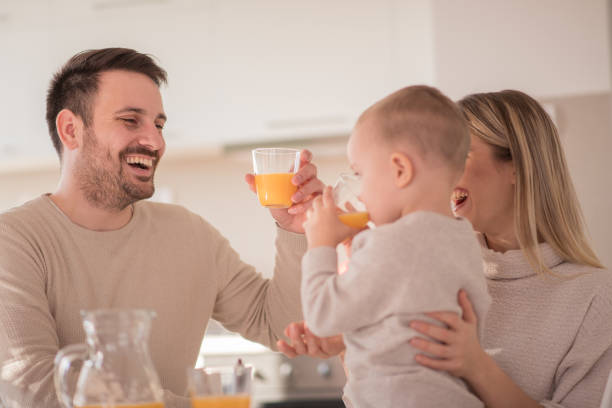 istock Happy family drinking orange juice 918695850