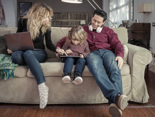 istock Parents with child using digital tablet at home 918696064