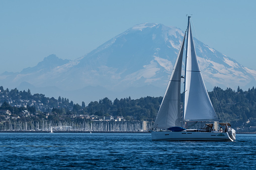 Sailing Vessel, One Man Wolfpack, transiting Seattle's Shilshole Bay with Mount Rainier in the backgrounds