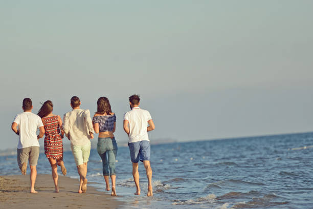 istock Friends fun on the beach under sunset sunlight. 918699366