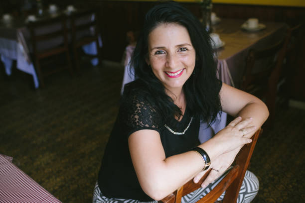 istock mature latin woman at cafe 918703098