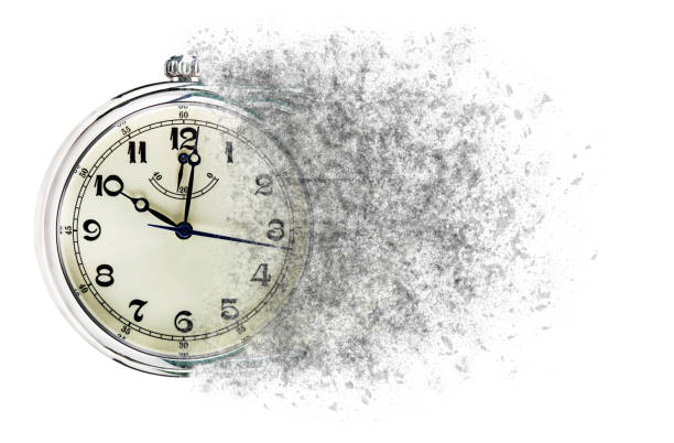 Time is running out concept shows clock that is dissolving away into little particles stock photo