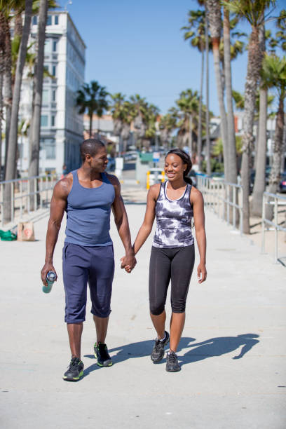 istock Couple Walking and Holding Hands on Santa Monica Beach 918711110