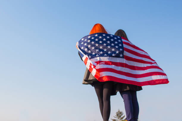 istock Two girls with USA flag. 918729334