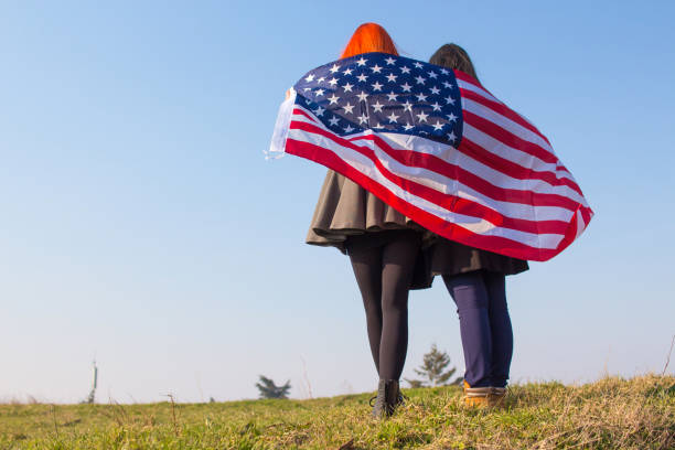 istock Two girls with USA flag. 918729398