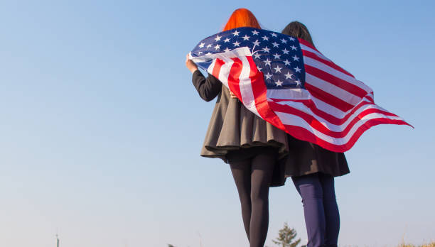 istock Two girls with USA flag. 918729414