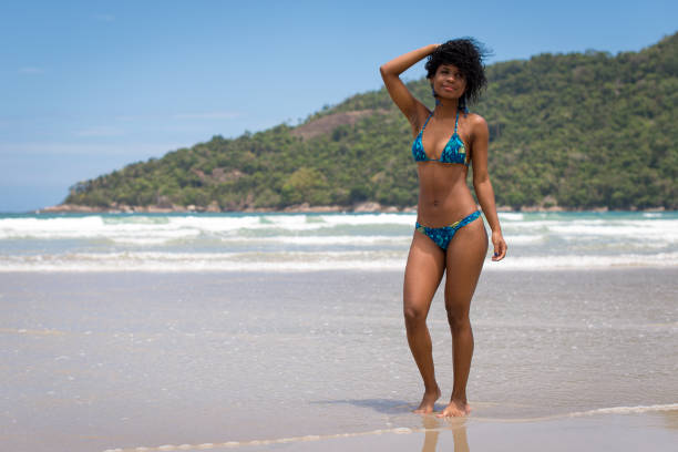 istock Young Woman at the Beach on her Knees 918729448