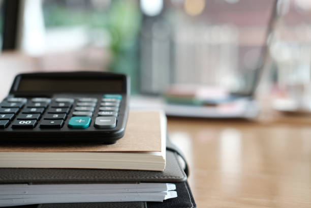 istock calculator, notebook on wood desk at office workplace. business, workspace, education concept. 918734106