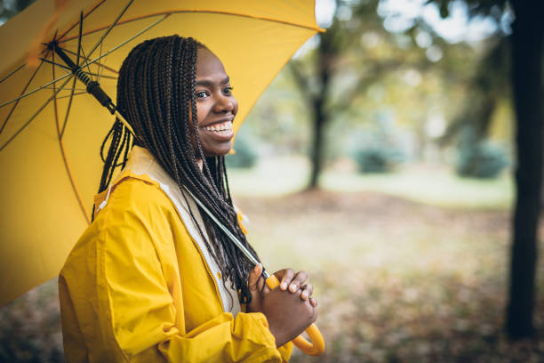 istock Young black woman in autumn walk through park 918740138
