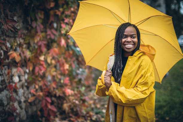 istock Young black woman in autumn walk through park 918740198