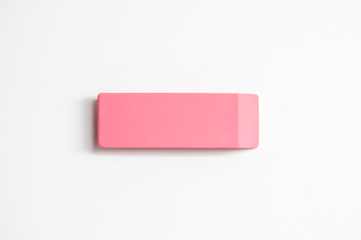 Pink eraser shot up close against a white background