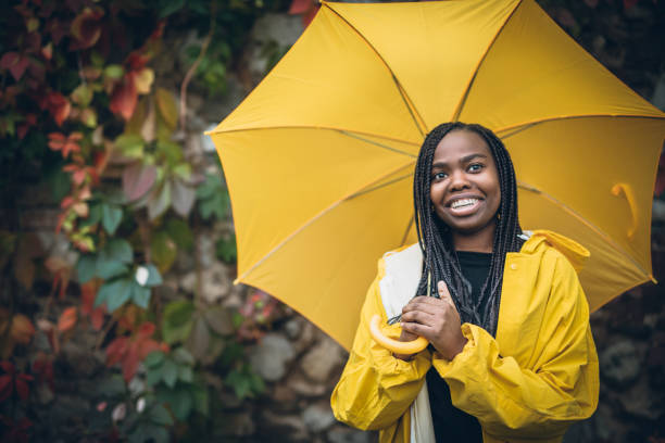 istock Young black woman in autumn walk through park 918740236