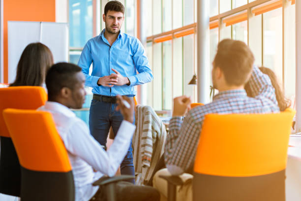 istock Group of casually dressed businesspeople discussing ideas in the office. 918740434