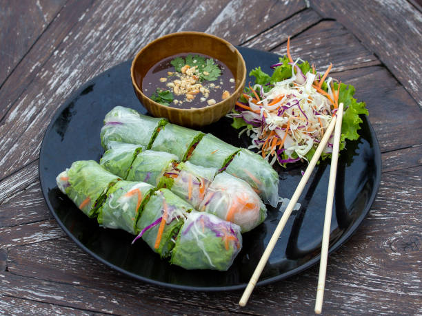 Fresh vietnamese spring rolls on a plate with salad stock photo