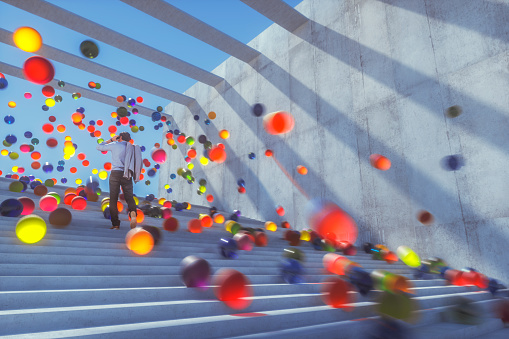 Large group of glowing spheres falling down the urban concrete stairs.