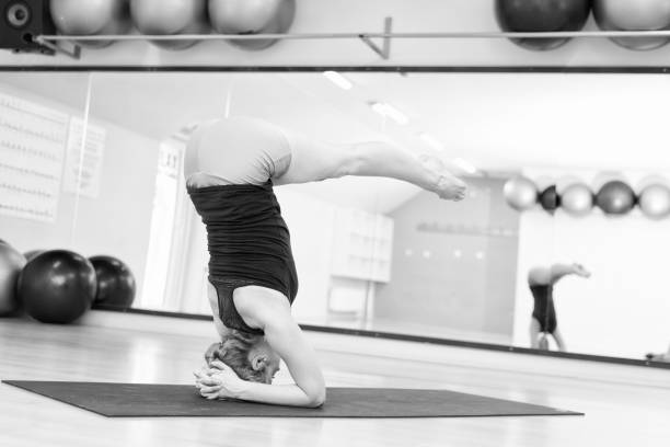 istock Middle aged woman doing yoga workout 918749574