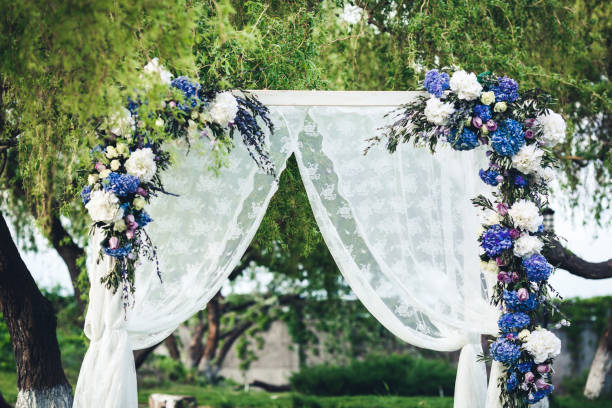 istock Wedding arch decorated with fabric and flowers. 918755588