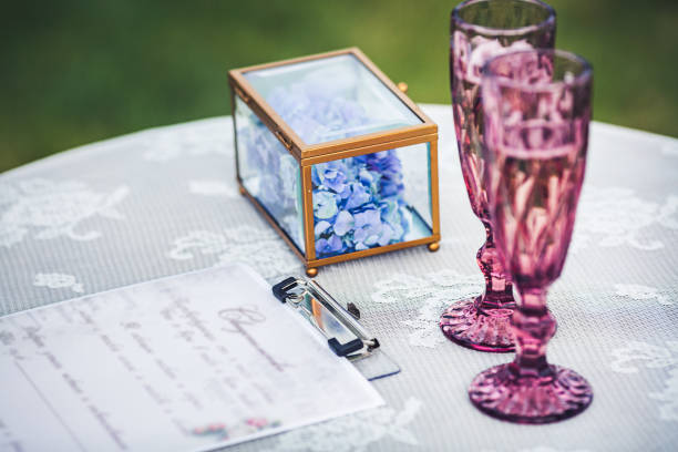 istock Two glasses, a wedding certificate and a floral decoration on the table. Wedding decorations. 918755616