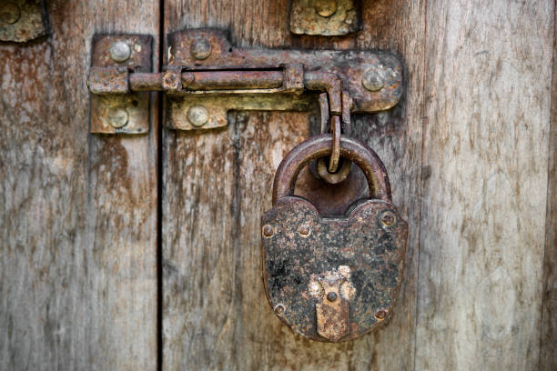 istock Vintage padlock on a old wooden door 918755658