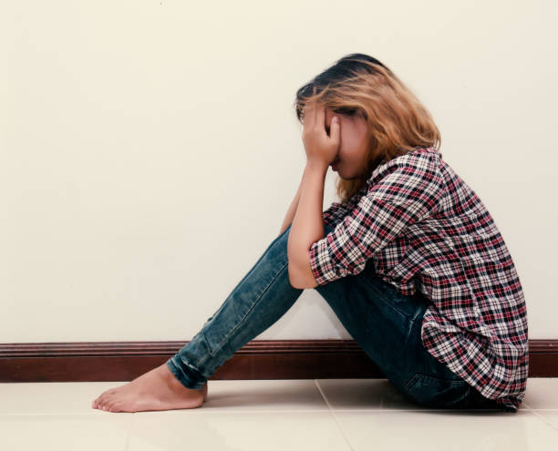 istock young hipster woman, sad, long-haired  sitting hugging legs. 918758322