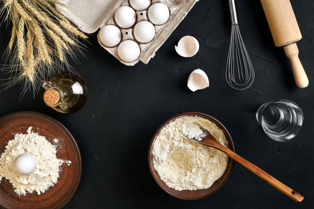 istock Pasta cooking ingredients on black kitchen table. Top view with space for your text 918760986