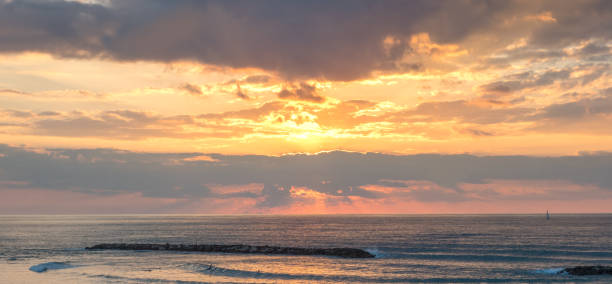 wide angle view of sailboat on mediterranean sea at sunset - sailboat sunset tel aviv sea imagens e fotografias de stock