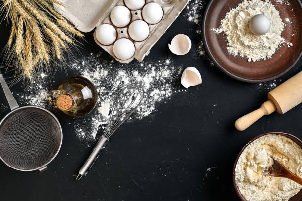 istock Pasta cooking ingredients on black kitchen table. Top view with space for your text 918763516