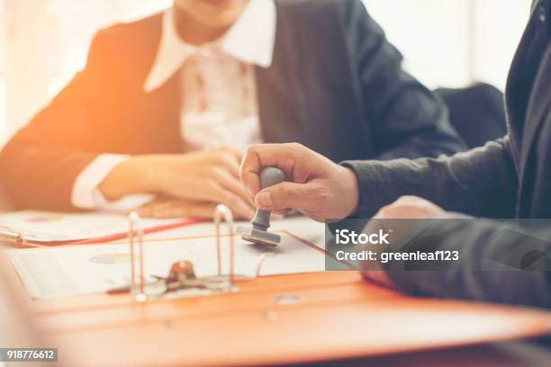 Business Hand Putting Stamp On A Document Close Up Stock Photo - Download Image Now
