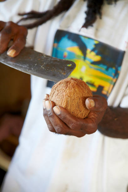 istock Afro Caribbean Man Shelling Coconut 918776650