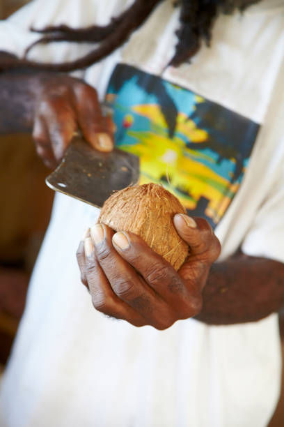 istock Afro Caribbean Man Shelling Coconut 918776740