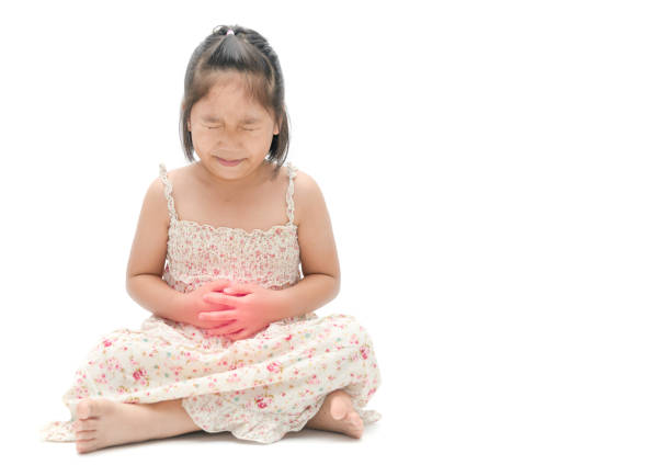 Girl inflating light green balloon on violet background, space for text